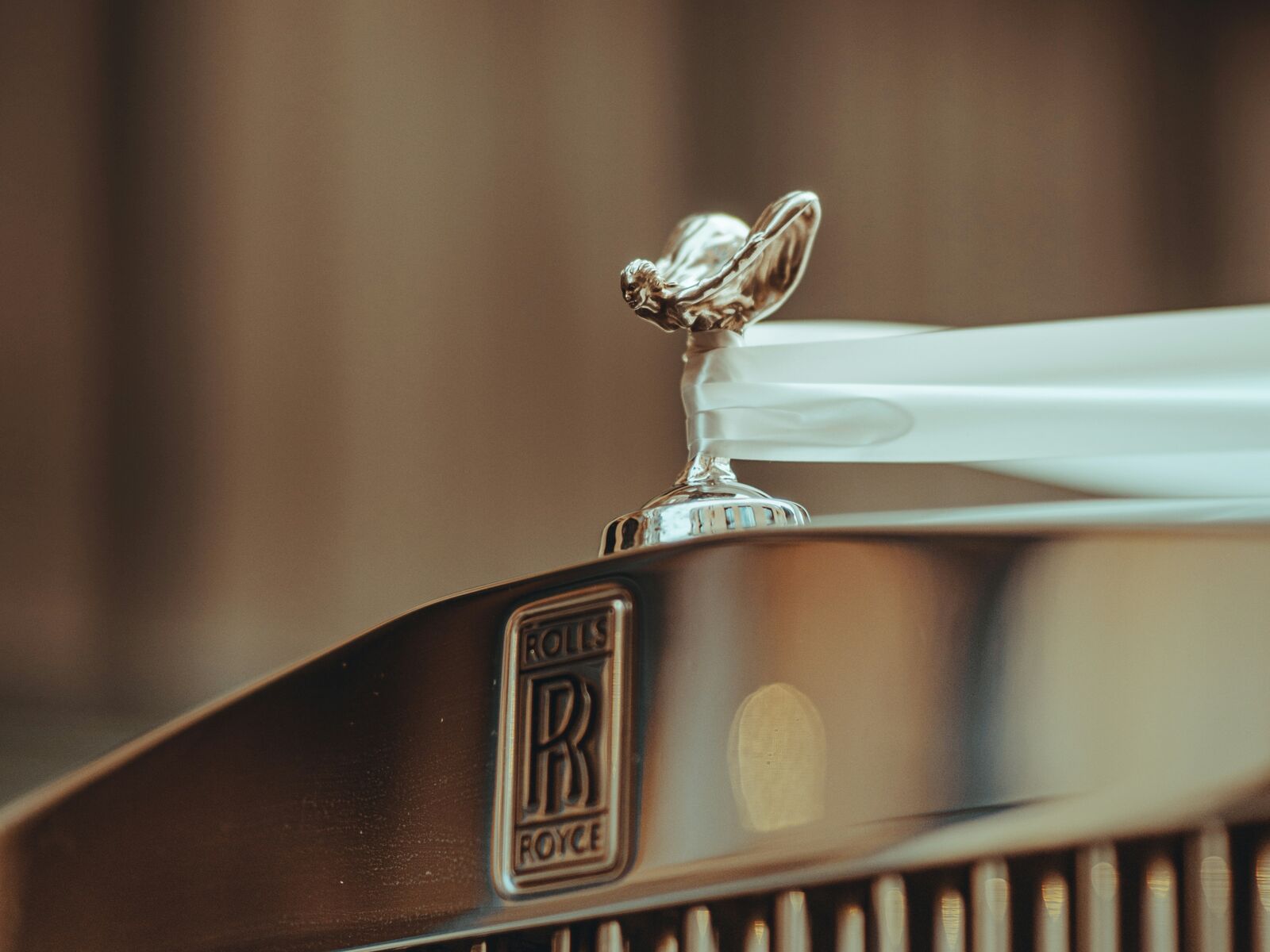 The Rolls-Royce badge and Spirit of Ecstasy on a polished grille